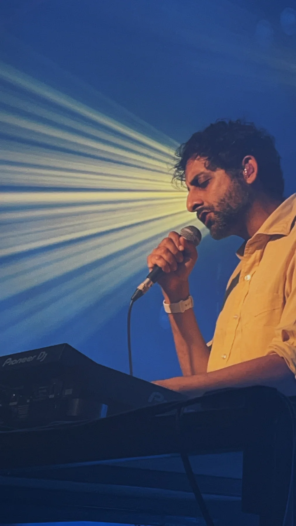 Performer lit by deep blue stage light