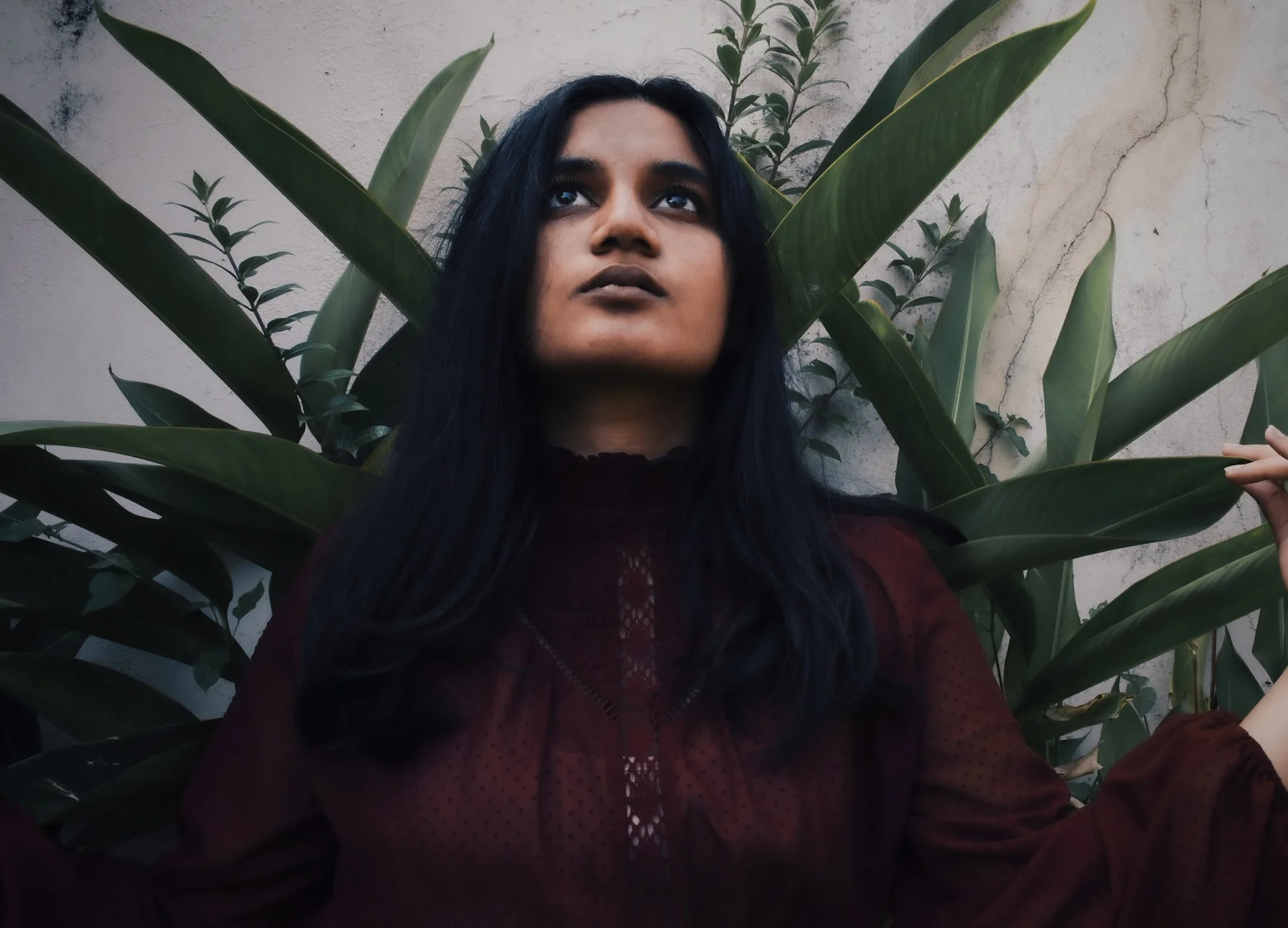 Portrait framed by dense green plants